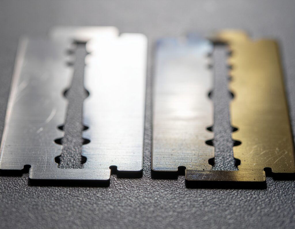 a detailed comparison shot showing a pristine new razor blade next to a worn, dull blade, with visible differences in the cutting edge highlighted