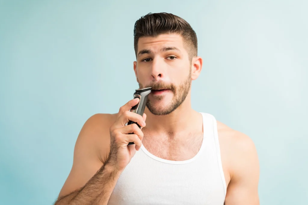 young man trimming mustaches